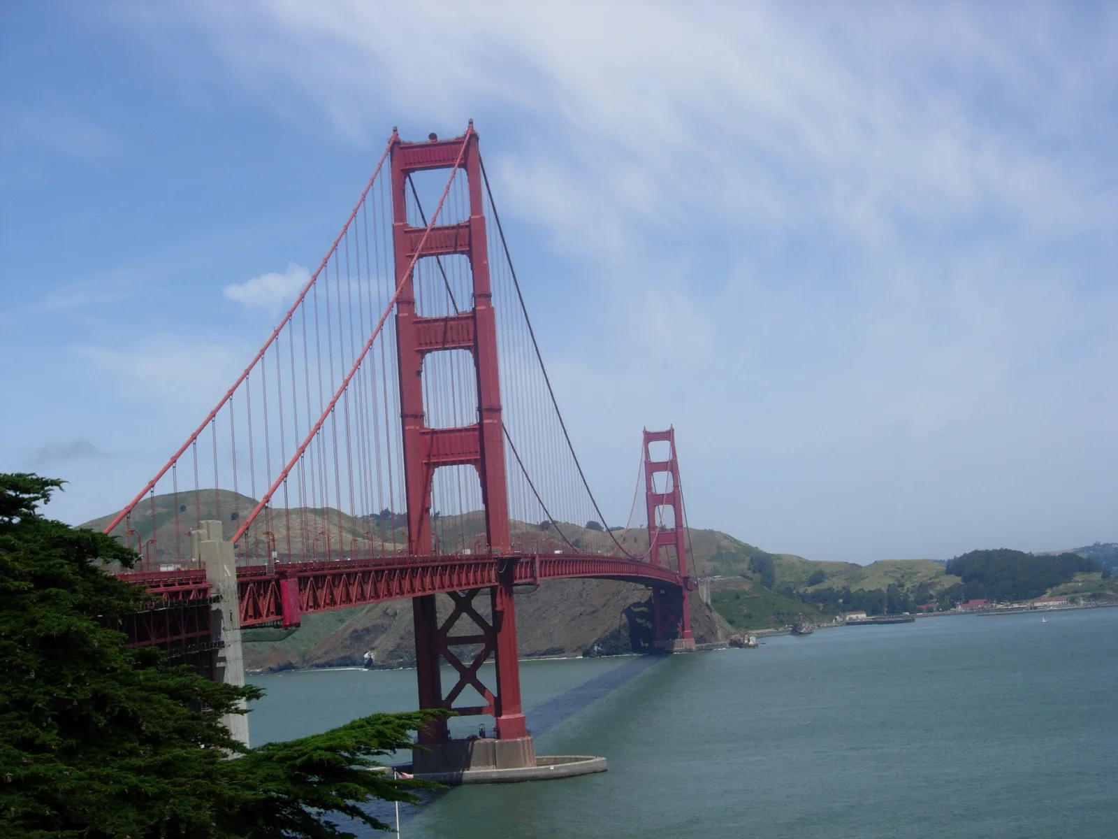 The Golden Gate Bridge spanning the strait in full, under a clear sky