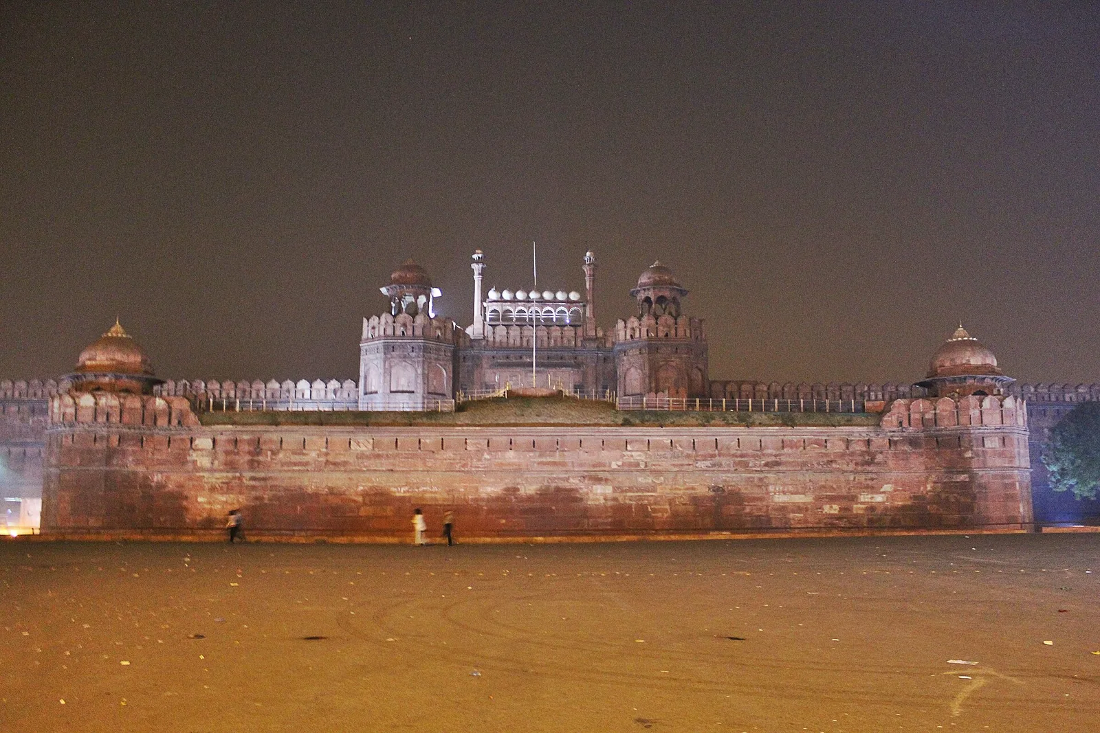 The Red Fort's Lahori Gate and sandstone walls lit up at night in Delhi