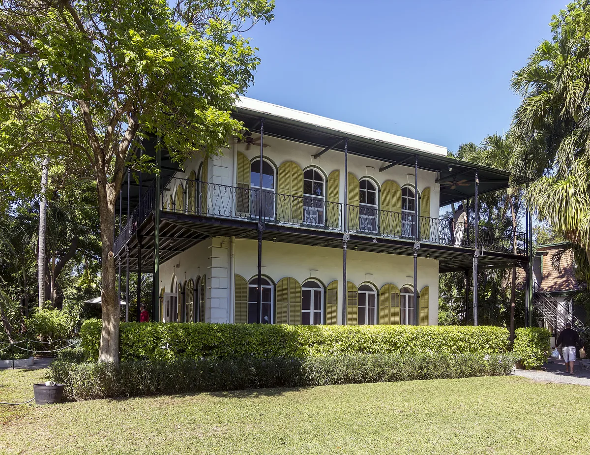 The Ernest Hemingway House in Key West with its green shutters, wraparound balcony and garden