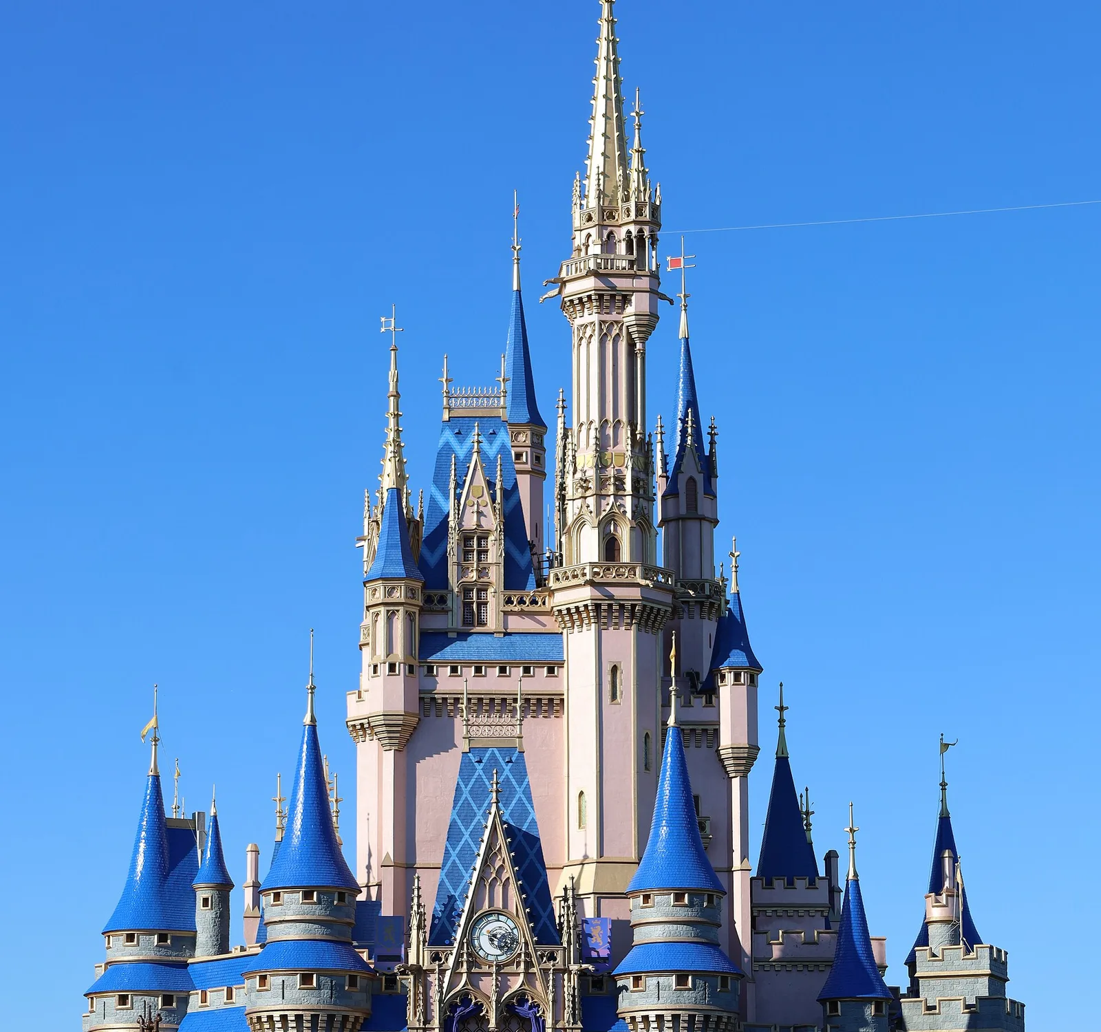 Cinderella Castle at the Magic Kingdom in its current pink and blue colours against a clear sky