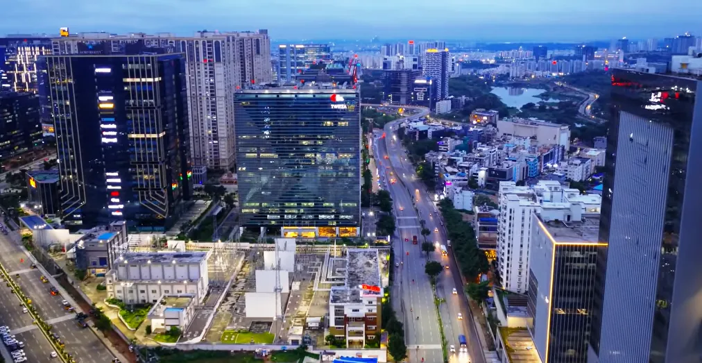 Hyderabad’s HITEC City skyline at dusk, office towers lit along a wide avenue