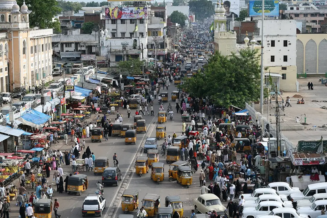 The busy market streets of Hyderabad’s Old City seen from the Charminar, with stalls, auto-rickshaws and crowds