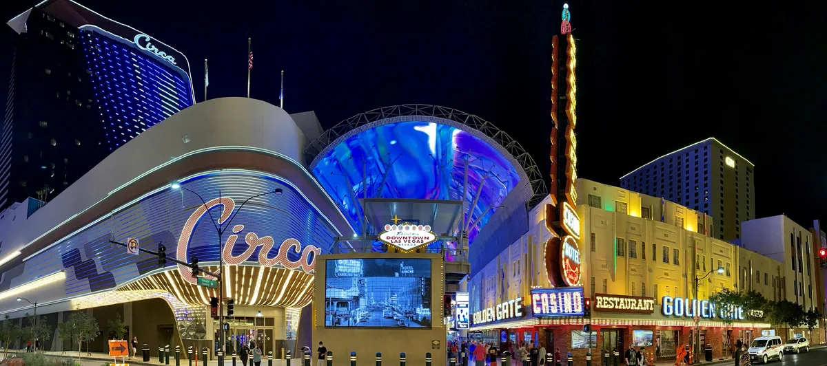 The entrance to the Fremont Street Experience at night, with the Circa resort on the left, the Golden Gate Casino on the right and the Viva Vision canopy overhead