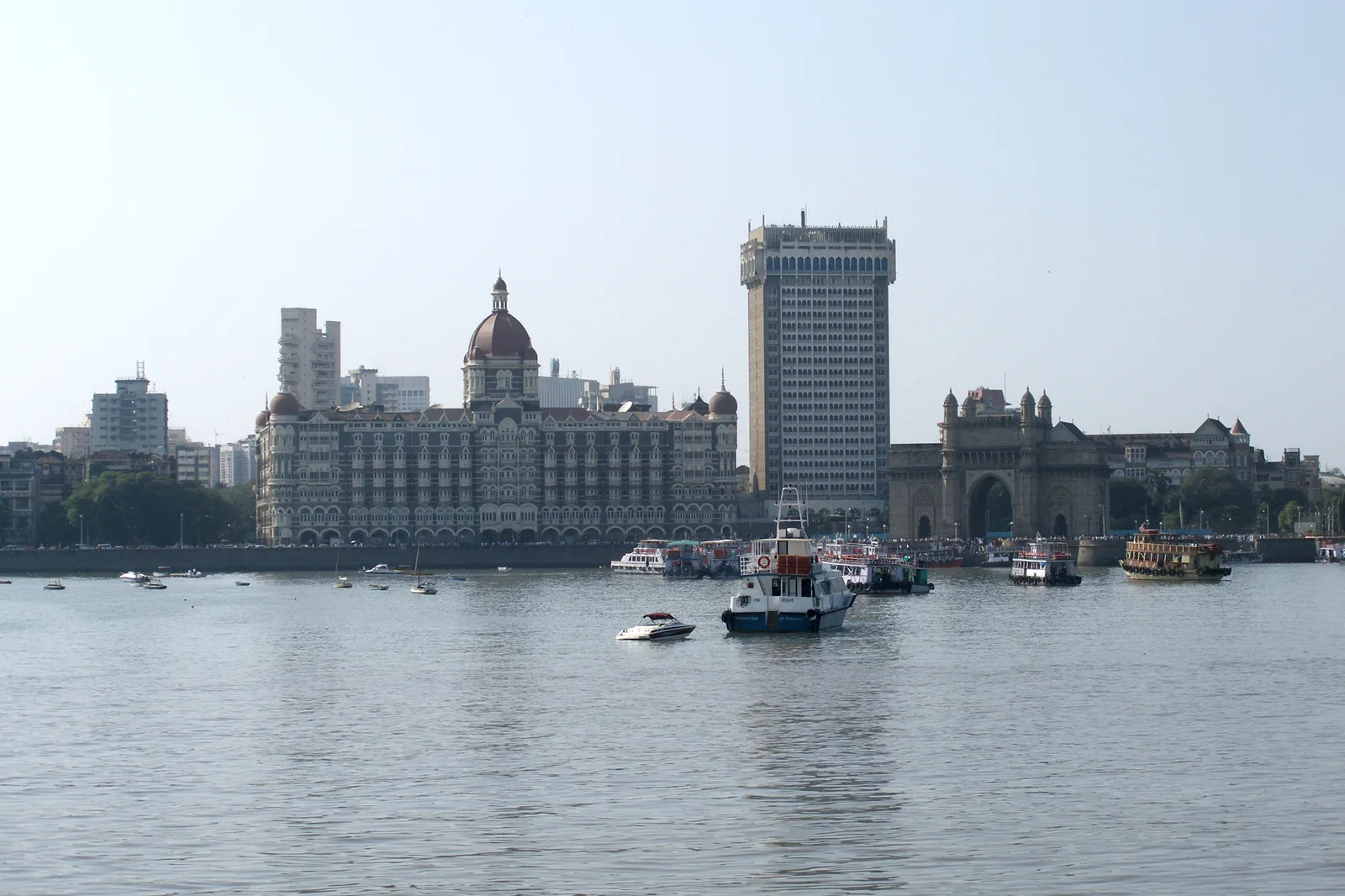 The Gateway of India and the Taj Mahal Palace Hotel seen from Mumbai harbour, with harbour boats