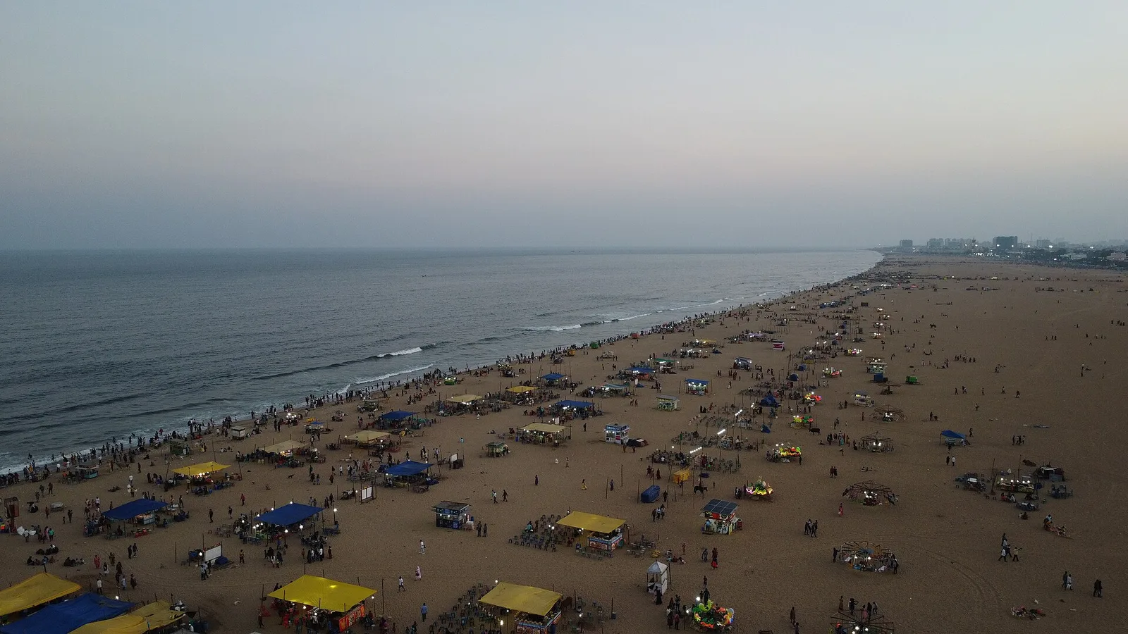 Marina Beach in Chennai at dusk, its stalls lit along the sand