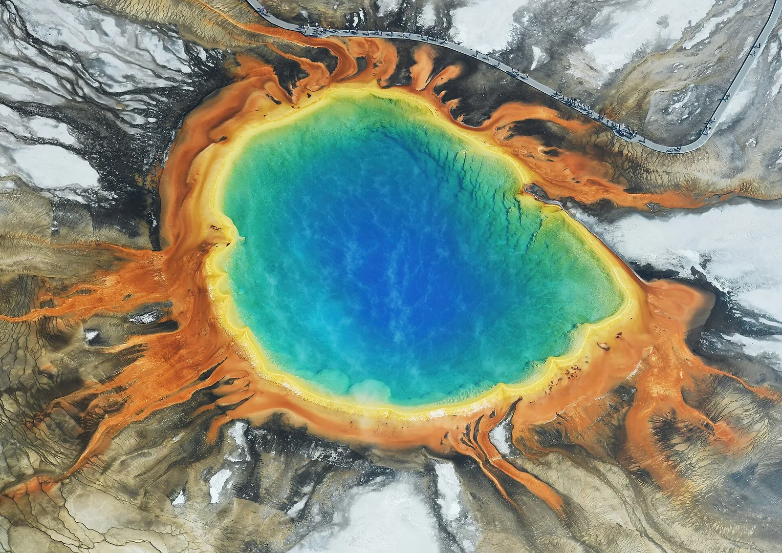 Grand Prismatic Spring from above, rings of orange microbial mat around a deep blue pool