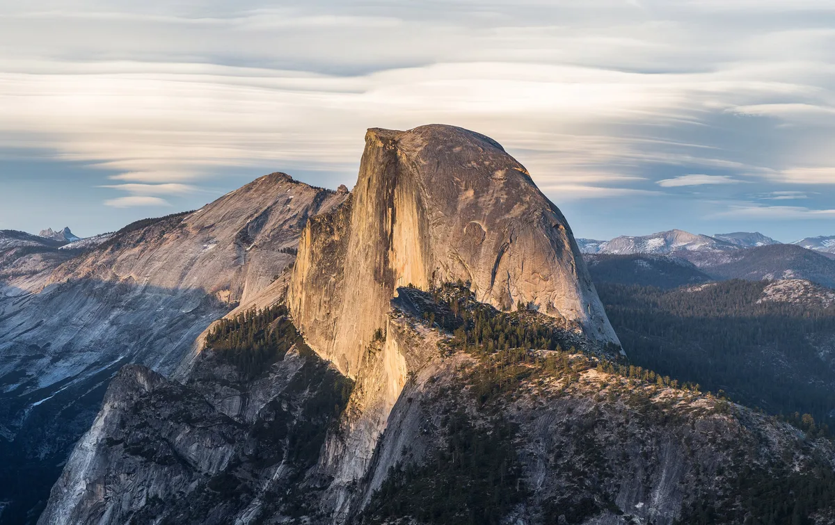 Half Dome catching golden evening light, seen from Glacier Point